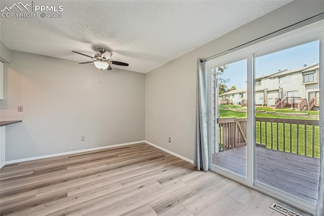 2013 Erin Loop, Colorado Springs, CO 80918 - unfurnished dining area with light wood-type flooring, a ceiling fan, baseboards, and a textured ceiling