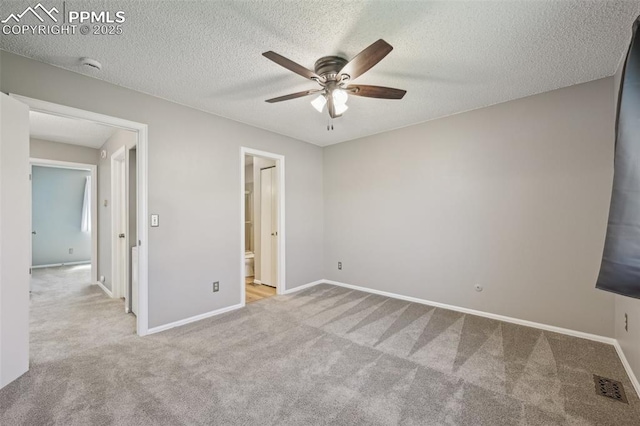 2013 Erin Loop, Colorado Springs, CO 80918 - unfurnished bedroom with carpet flooring, baseboards, a textured ceiling, ensuite bathroom, and ceiling fan