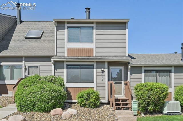 2013 Erin Loop, Colorado Springs, CO 80918 - view of property with entry steps, central AC unit, and roof with shingles