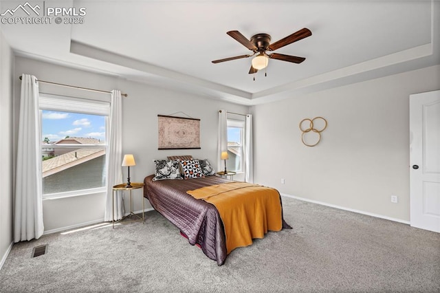 8370 Lupan Dr, Colorado Springs, CO 80951 - bedroom with a tray ceiling, carpet floors, and a ceiling fan
