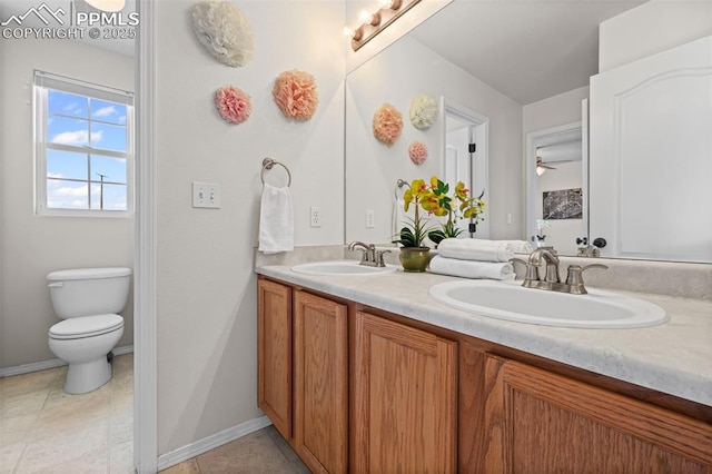 8370 Lupan Dr, Colorado Springs, CO 80951 - bathroom with double vanity, a ceiling fan, and tile patterned floors