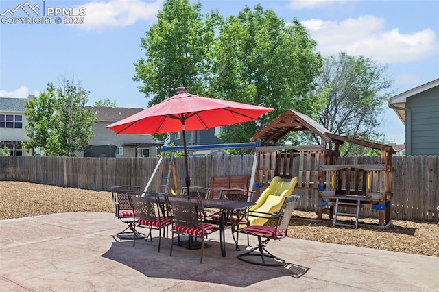 8370 Lupan Dr, Colorado Springs, CO 80951 - fenced backyard with a playground, a patio, and outdoor dining space