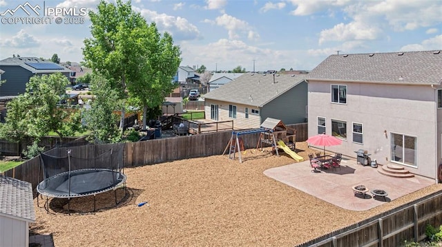 8370 Lupan Dr, Colorado Springs, CO 80951 - fenced backyard featuring a trampoline, a playground, a patio, and a residential view
