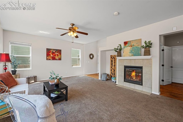 8370 Lupan Dr, Colorado Springs, CO 80951 - living area featuring carpet, a ceiling fan, a tiled fireplace, and plenty of natural light