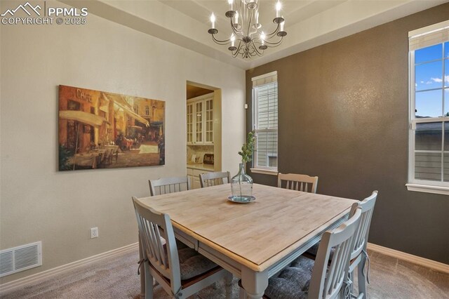 6874 Quiet Pond Pl, Colorado Springs, CO 80923 - dining space with carpet flooring, a chandelier, and baseboards