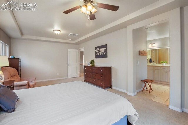 6874 Quiet Pond Pl, Colorado Springs, CO 80923 - bedroom with carpet flooring, a tray ceiling, baseboards, and tile patterned floors