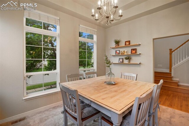 6874 Quiet Pond Pl, Colorado Springs, CO 80923 - dining space featuring stairs, a chandelier, wood finished floors, and baseboards