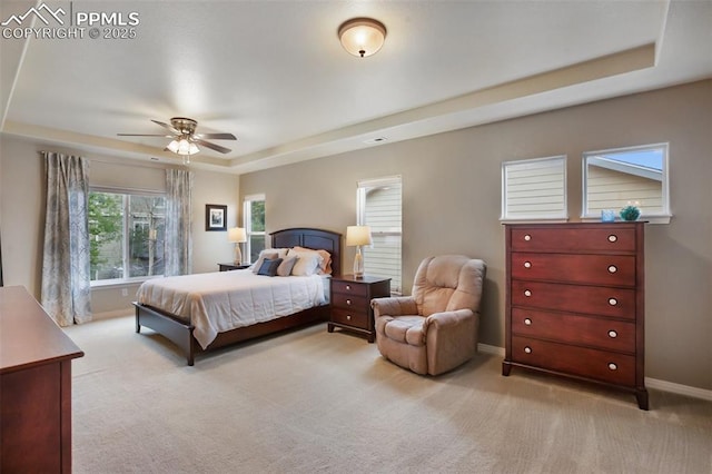 6874 Quiet Pond Pl, Colorado Springs, CO 80923 - bedroom with a tray ceiling, light colored carpet, baseboards, and ceiling fan