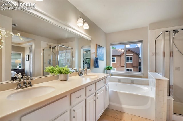 6874 Quiet Pond Pl, Colorado Springs, CO 80923 - ensuite bathroom featuring a shower stall, a garden tub, double vanity, and tile patterned flooring