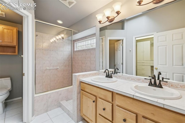 14115 Nichlas Ct, Colorado Springs, CO 80921 - full bath featuring tiled shower, toilet, double vanity, and tile patterned flooring