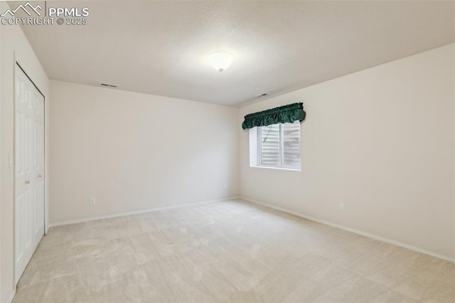 14115 Nichlas Ct, Colorado Springs, CO 80921 - unfurnished bedroom featuring light carpet, baseboards, and a closet