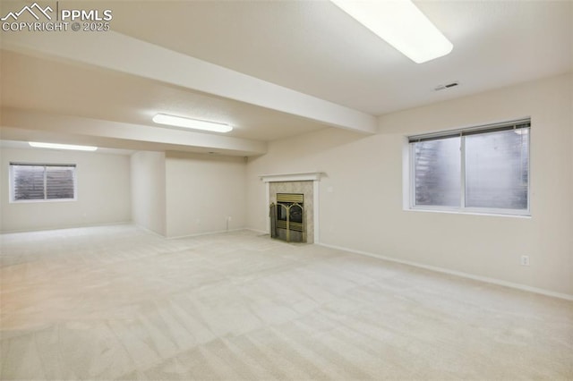 14115 Nichlas Ct, Colorado Springs, CO 80921 - unfurnished living room featuring a tile fireplace, light colored carpet, and baseboards