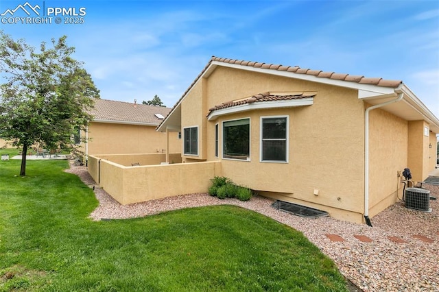 14115 Nichlas Ct, Colorado Springs, CO 80921 - back of property featuring stucco siding, a lawn, and a tiled roof