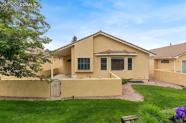 14115 Nichlas Ct, Colorado Springs, CO 80921 - rear view of house featuring stucco siding, a tile roof, and a gate