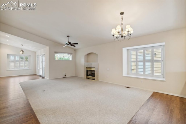 14115 Nichlas Ct, Colorado Springs, CO 80921 - unfurnished living room with a fireplace, ceiling fan, a chandelier, wood finished floors, and lofted ceiling
