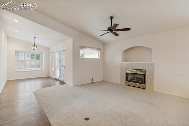 14115 Nichlas Ct, Colorado Springs, CO 80921 - unfurnished living room with vaulted ceiling, a high end fireplace, ceiling fan, baseboards, and wood finished floors