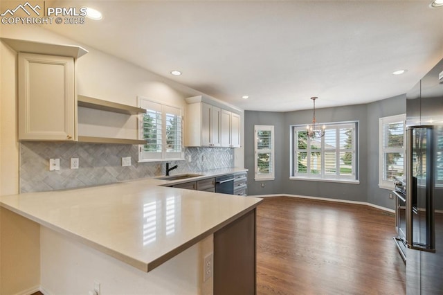 14115 Nichlas Ct, Colorado Springs, CO 80921 - kitchen with stainless steel dishwasher, healthy amount of natural light, light countertops, dark wood-style flooring, and recessed lighting