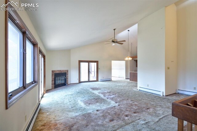 7770 N Topeka Ave, Cascade, CO 80809 - unfurnished living room with baseboard heating, high vaulted ceiling, a tile fireplace, carpet, and a baseboard heating unit