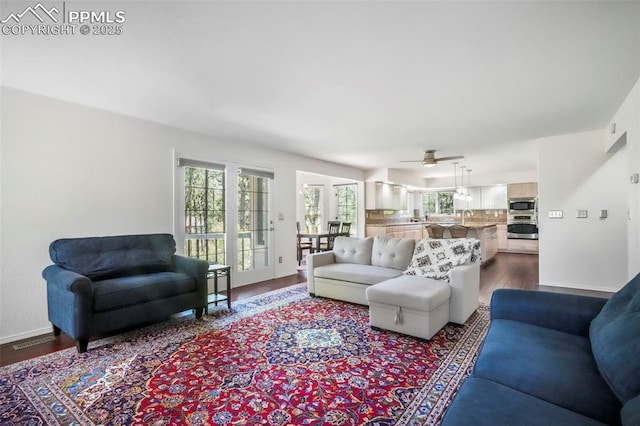 1240 Lone Scout Lookout, Monument, CO 80132 - living room featuring dark wood-style flooring and a ceiling fan