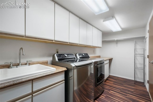 1240 Lone Scout Lookout, Monument, CO 80132 - washroom featuring washer and clothes dryer, cabinet space, and dark wood-style flooring