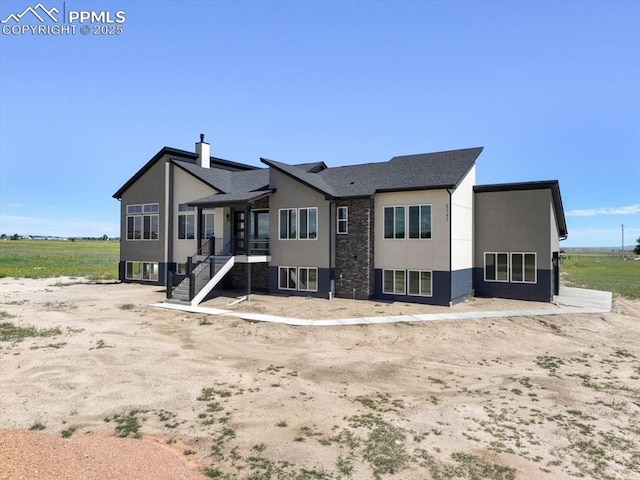 8545 Bailiff Dr, Peyton, CO 80831 - rear view of property featuring stairway and a chimney