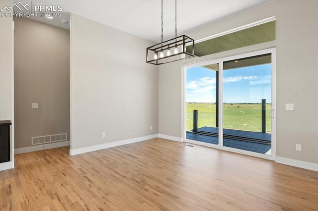 8545 Bailiff Dr, Peyton, CO 80831 - unfurnished dining area featuring wood finished floors, baseboards, and a chandelier
