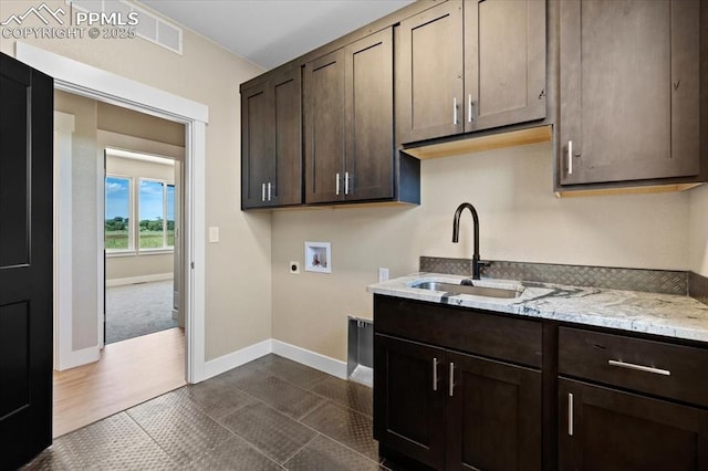 8545 Bailiff Dr, Peyton, CO 80831 - laundry area featuring hookup for a washing machine, cabinet space, electric dryer hookup, baseboards, and dark tile patterned flooring