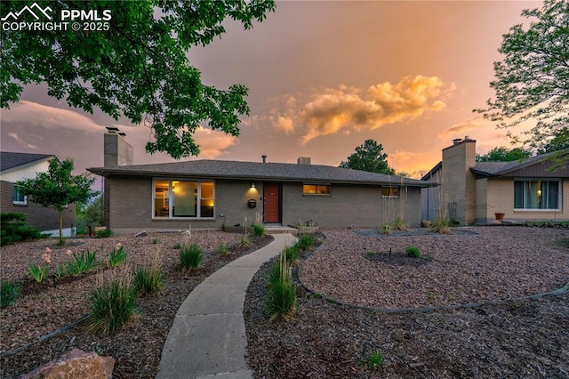 2206 Patrician Way, Colorado Springs, CO 80909 - single story home featuring brick siding and a chimney