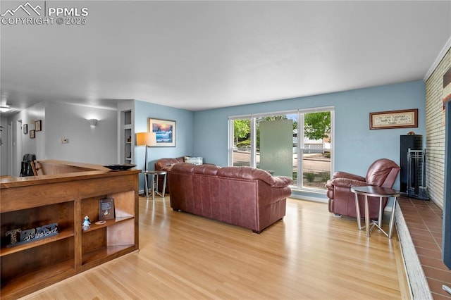2206 Patrician Way, Colorado Springs, CO 80909 - living area featuring light wood-style floors and a brick fireplace