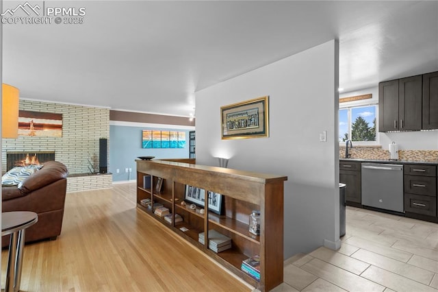 2206 Patrician Way, Colorado Springs, CO 80909 - hall with plenty of natural light, light wood-type flooring, baseboards, and a sink