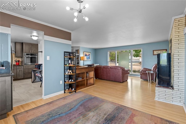 2206 Patrician Way, Colorado Springs, CO 80909 - living area with light wood finished floors, a chandelier, and crown molding