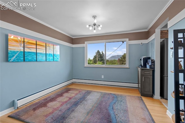 2206 Patrician Way, Colorado Springs, CO 80909 - unfurnished bedroom featuring a chandelier, light wood-style flooring, baseboard heating, ornamental molding, and baseboards