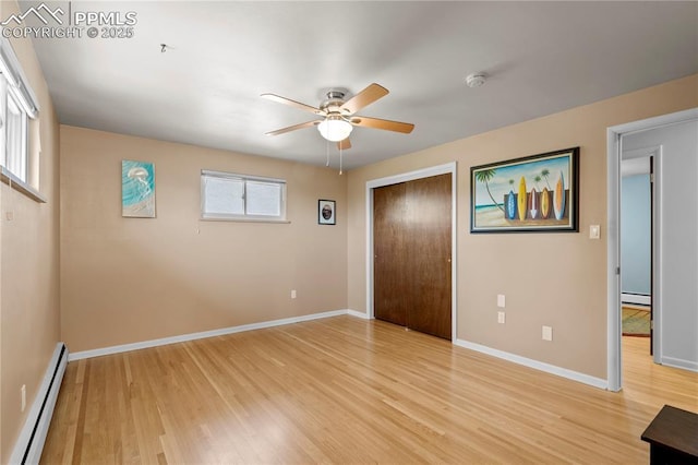 2206 Patrician Way, Colorado Springs, CO 80909 - empty room with a baseboard heating unit, light wood-style flooring, a ceiling fan, and baseboard heating