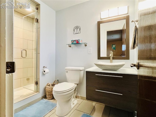 2206 Patrician Way, Colorado Springs, CO 80909 - bathroom with vanity, tile patterned flooring, a shower stall, baseboards, and toilet