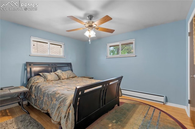 2206 Patrician Way, Colorado Springs, CO 80909 - bedroom with baseboard heating, wood finished floors, baseboards, and a ceiling fan