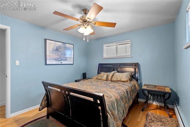 2206 Patrician Way, Colorado Springs, CO 80909 - bedroom with baseboard heating, wood finished floors, and baseboards