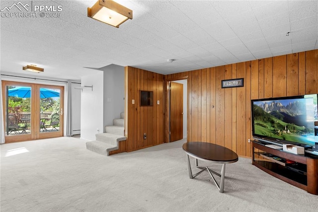 2206 Patrician Way, Colorado Springs, CO 80909 - living room with carpet, stairs, wooden walls, and baseboard heating