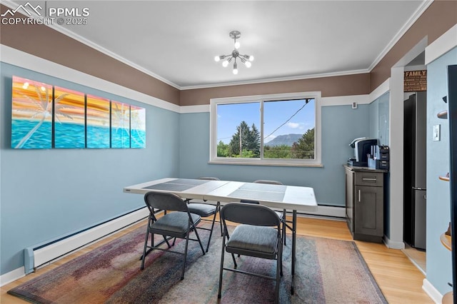 2206 Patrician Way, Colorado Springs, CO 80909 - dining space with a baseboard heating unit, light wood-style floors, plenty of natural light, a chandelier, and ornamental molding