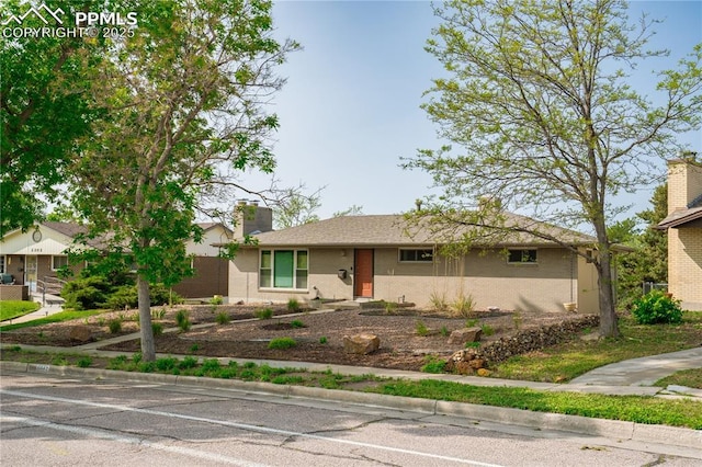 2206 Patrician Way, Colorado Springs, CO 80909 - ranch-style home featuring brick siding and a chimney