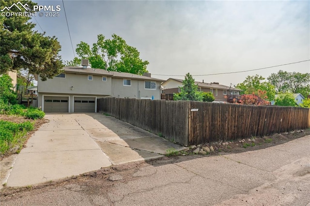 2206 Patrician Way, Colorado Springs, CO 80909 - view of front of property with concrete driveway, stucco siding, and a garage