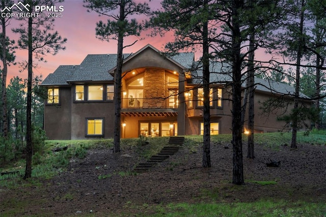 8395 Bar X Ter, Colorado Springs, CO 80908 - back of house with stucco siding, a balcony, and a shingled roof