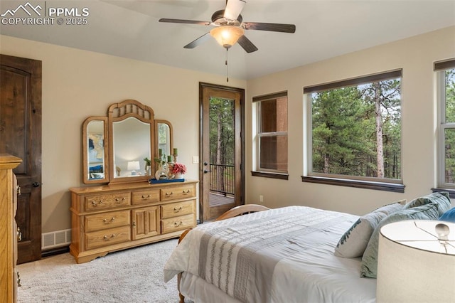 8395 Bar X Ter, Colorado Springs, CO 80908 - bedroom with access to outside, multiple windows, light carpet, and a ceiling fan