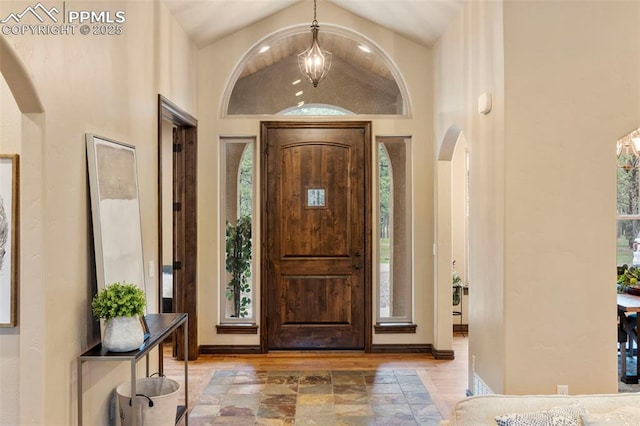 8395 Bar X Ter, Colorado Springs, CO 80908 - foyer with arched walkways, lofted ceiling, and wood finished floors
