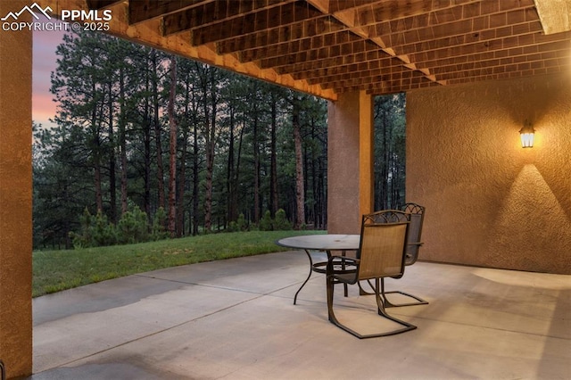 8395 Bar X Ter, Colorado Springs, CO 80908 - patio terrace at dusk featuring a patio area and outdoor dining space