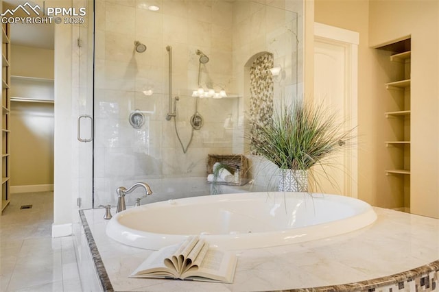 5085 Saxton Hollow Rd, Colorado Springs, CO 80908 - bathroom featuring a stall shower, a garden tub, built in features, and a spacious closet