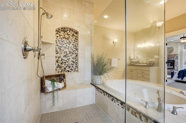 5085 Saxton Hollow Rd, Colorado Springs, CO 80908 - full bathroom with a jetted tub, tiled shower, a ceiling fan, ensuite bath, and vanity