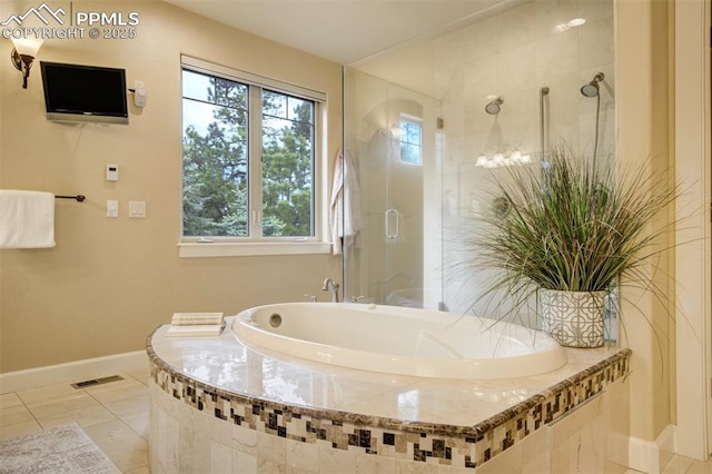 5085 Saxton Hollow Rd, Colorado Springs, CO 80908 - full bathroom featuring a garden tub, a stall shower, and tile patterned floors