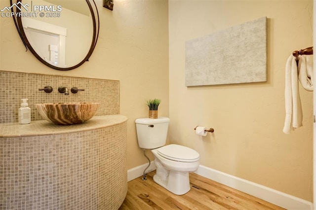 5085 Saxton Hollow Rd, Colorado Springs, CO 80908 - bathroom with wood finished floors and toilet