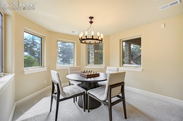 5085 Saxton Hollow Rd, Colorado Springs, CO 80908 - dining room featuring a chandelier, plenty of natural light, and carpet