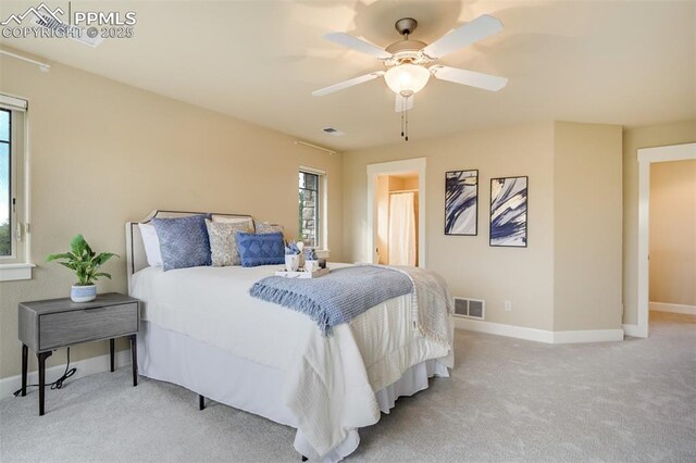 5085 Saxton Hollow Rd, Colorado Springs, CO 80908 - bedroom featuring light carpet, multiple windows, and ceiling fan